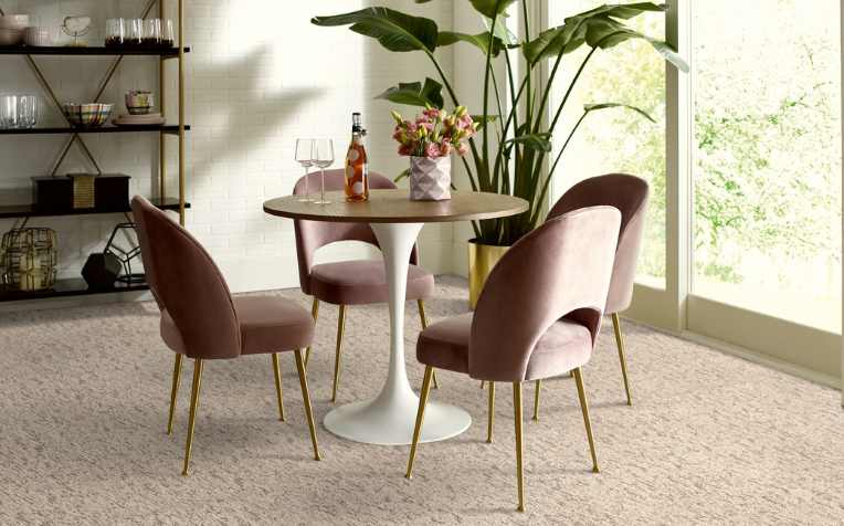 plush beige patterned carpet in modern room with pink and gold accent chairs